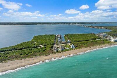 bird's eye view featuring a water view and a beach view