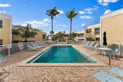 community pool featuring a patio and fence