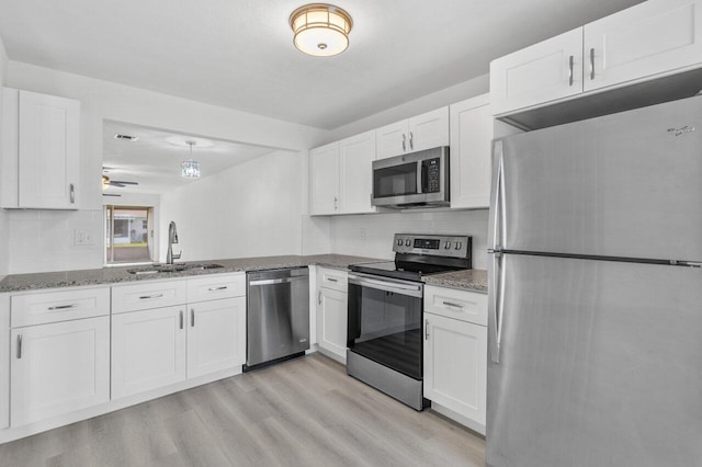 kitchen with sink, white cabinetry, ceiling fan, and appliances with stainless steel finishes