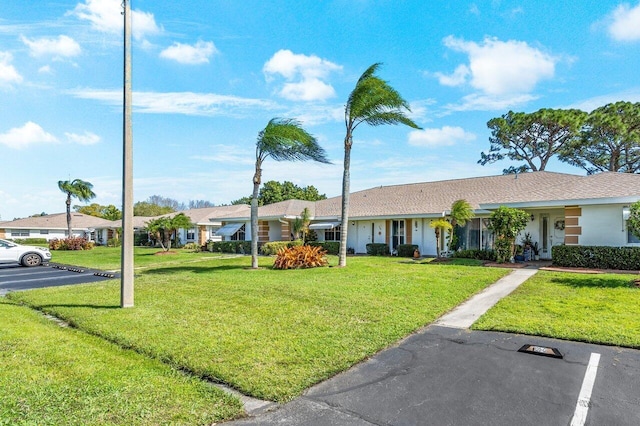 single story home featuring a front yard