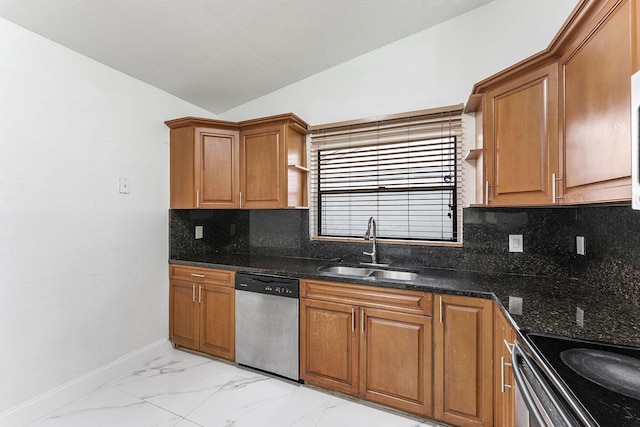 kitchen featuring sink, lofted ceiling, dark stone countertops, tasteful backsplash, and stainless steel dishwasher