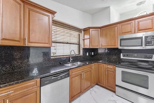 kitchen featuring sink, dark stone countertops, decorative backsplash, stainless steel appliances, and a textured ceiling