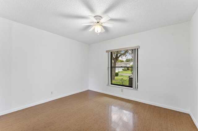 spare room with wood-type flooring, ceiling fan, and a textured ceiling