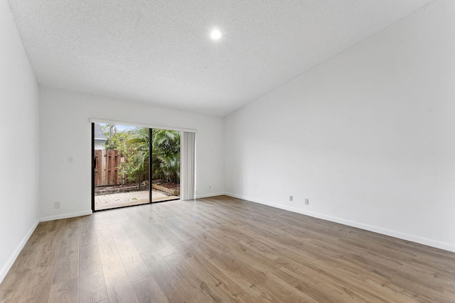 empty room featuring light hardwood / wood-style flooring and a textured ceiling