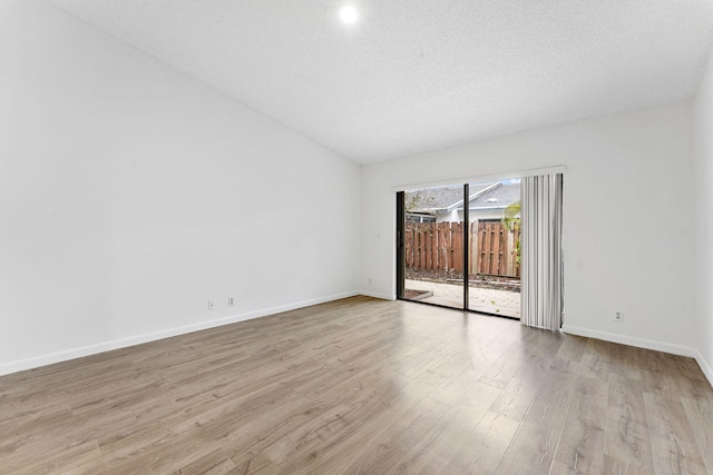 unfurnished room featuring a textured ceiling and light wood-type flooring