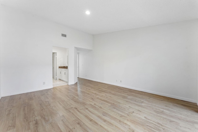 spare room with light wood-type flooring