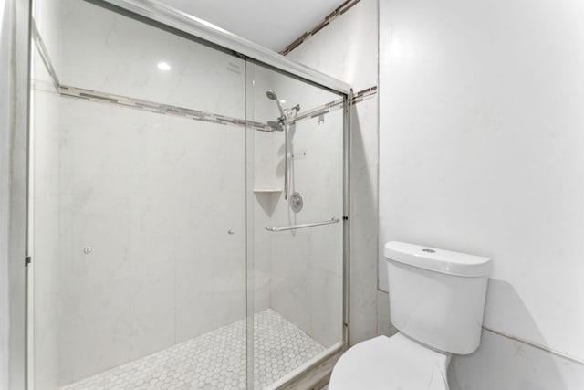 bathroom with walk in shower and toilet