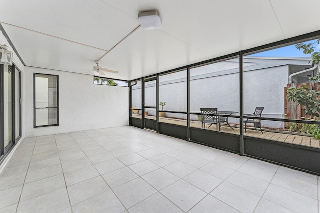 unfurnished sunroom featuring ceiling fan