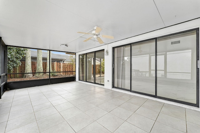 unfurnished sunroom featuring ceiling fan