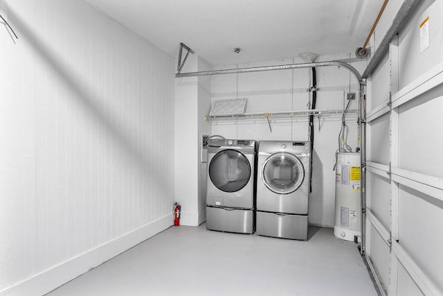 washroom featuring washing machine and clothes dryer and electric water heater