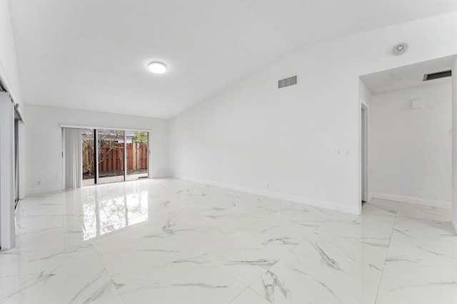 unfurnished room with lofted ceiling