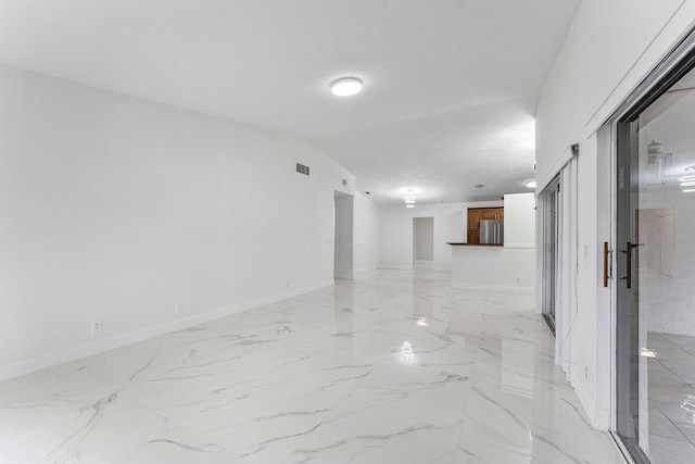 unfurnished room featuring lofted ceiling