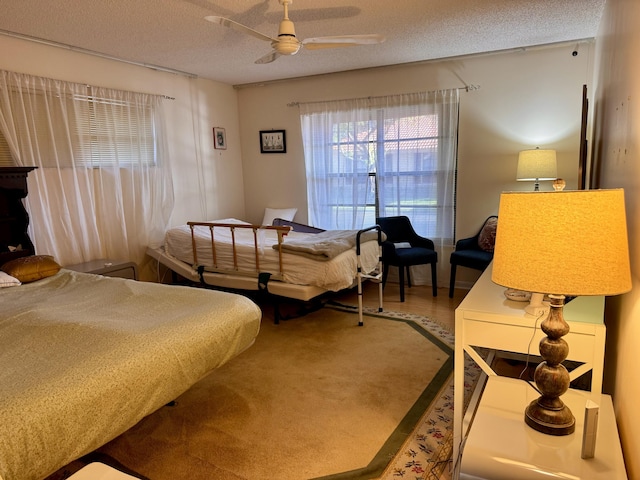 bedroom featuring ceiling fan and a textured ceiling