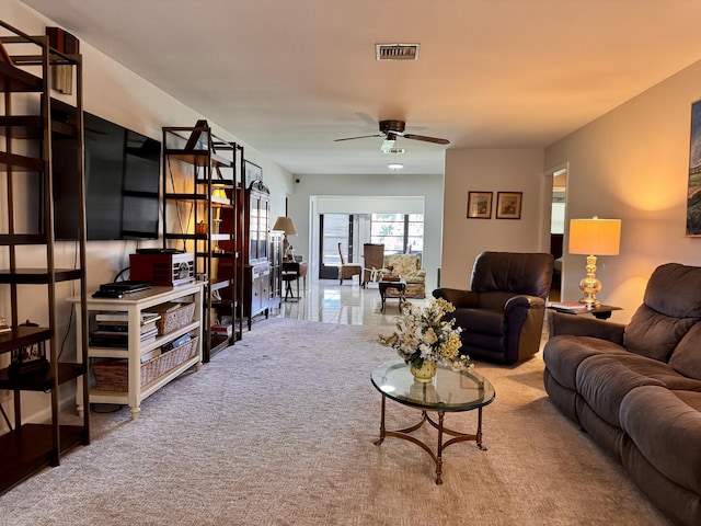 living room featuring carpet flooring and ceiling fan