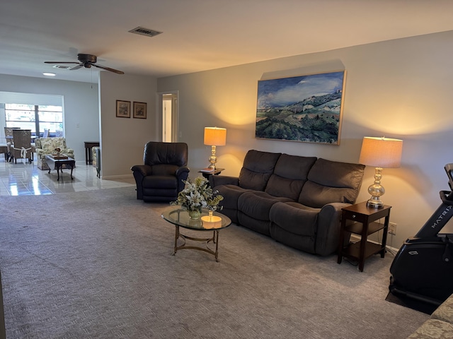 living room with ceiling fan and carpet