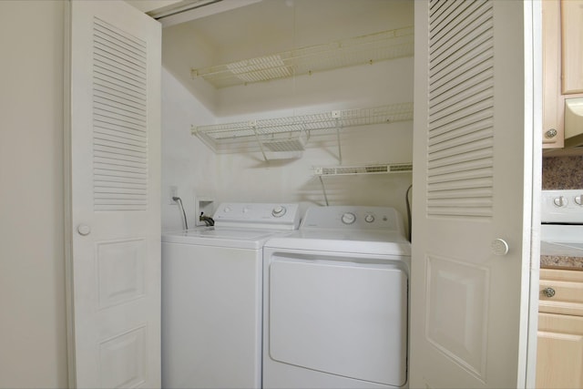 clothes washing area featuring washing machine and clothes dryer