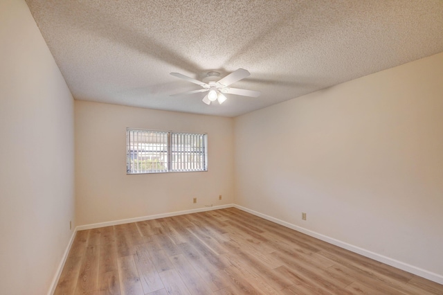 spare room featuring a textured ceiling, light hardwood / wood-style floors, and ceiling fan