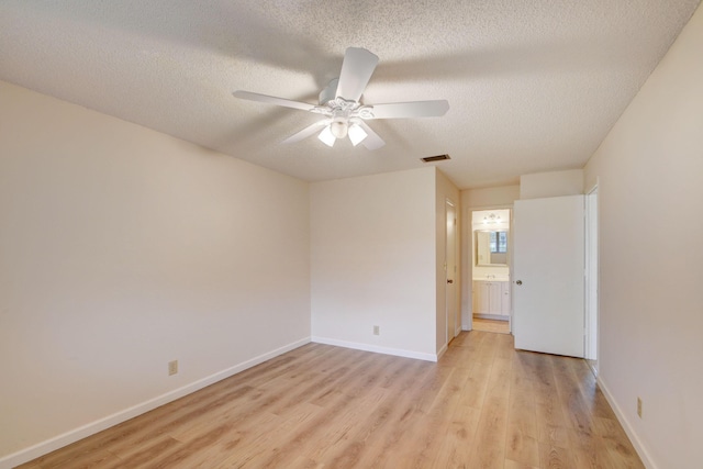 unfurnished room with ceiling fan, a textured ceiling, and light hardwood / wood-style flooring