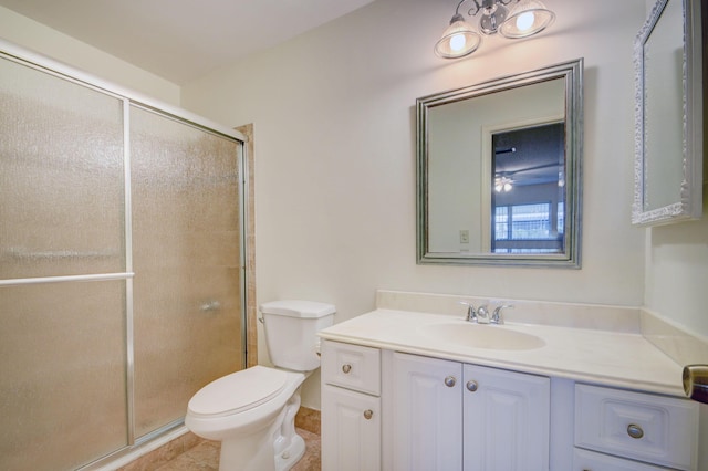 bathroom with tile patterned flooring, vanity, toilet, and an enclosed shower