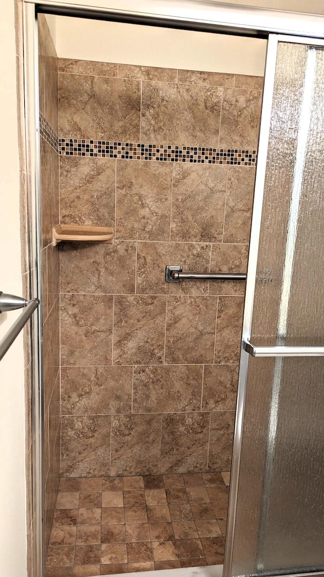 bathroom with a shower with shower door