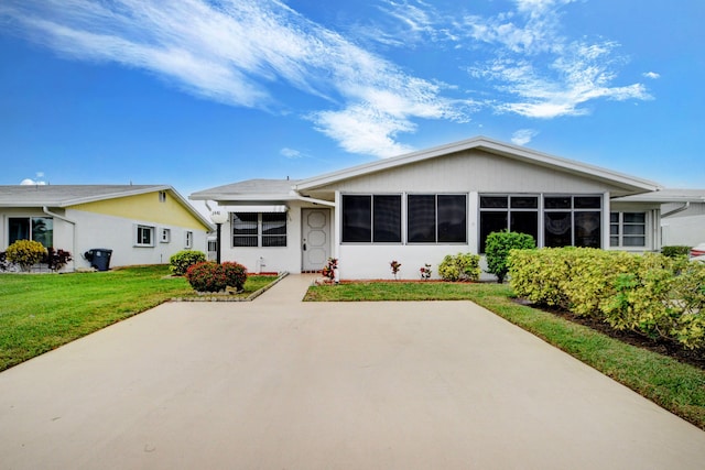 rear view of house featuring a patio area and a yard