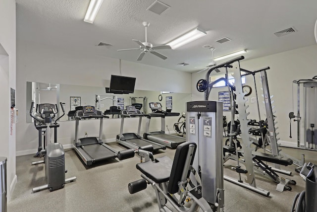 workout area with ceiling fan and a textured ceiling