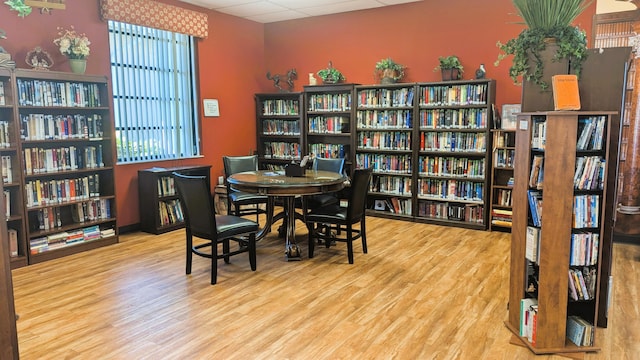 dining room with hardwood / wood-style flooring and a drop ceiling