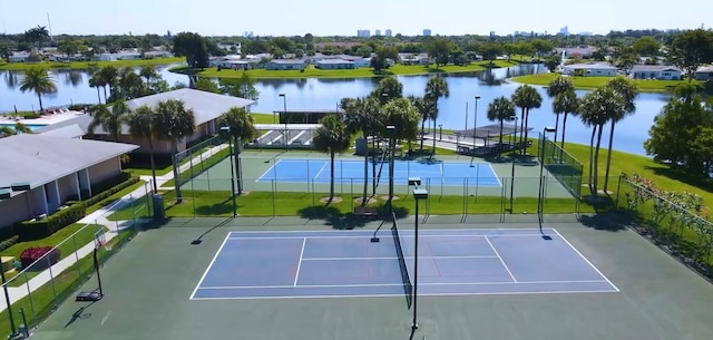 view of sport court featuring a water view and basketball court