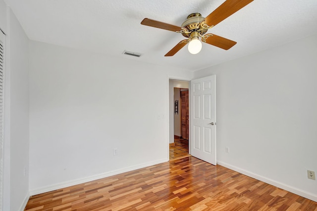 spare room featuring ceiling fan and light hardwood / wood-style flooring