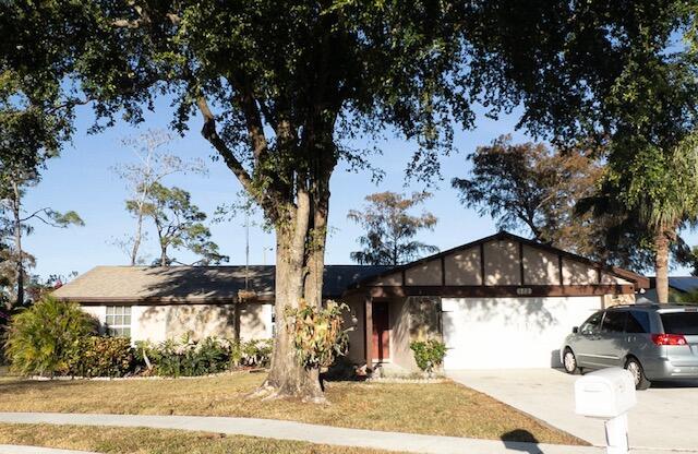 ranch-style house featuring a front yard and a garage