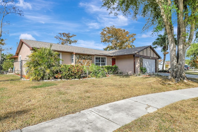 view of front of property with a front yard and a garage