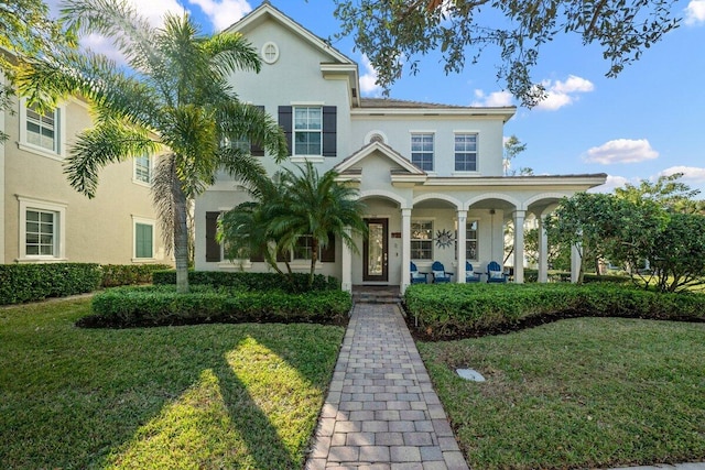 mediterranean / spanish-style home with a porch and a front yard