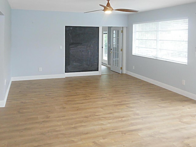 unfurnished living room featuring ceiling fan and light hardwood / wood-style flooring