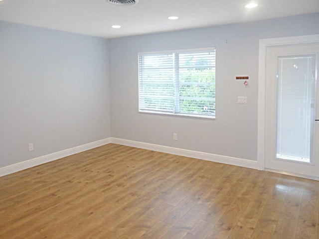 empty room with hardwood / wood-style floors