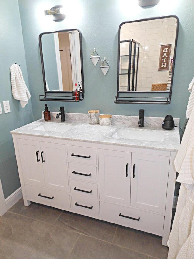 bathroom featuring tile patterned floors, vanity, and a shower