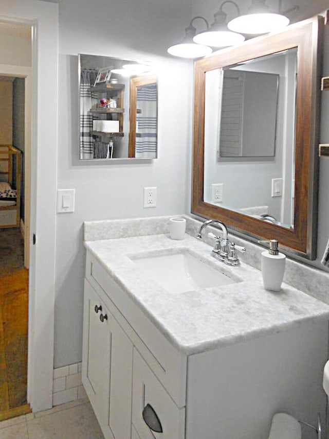 bathroom with tile patterned floors and vanity