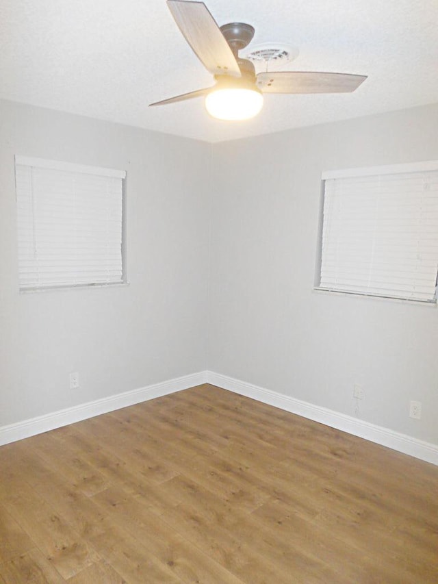 unfurnished room featuring hardwood / wood-style flooring and ceiling fan