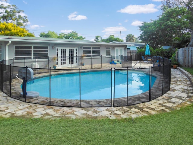 view of swimming pool with french doors and a patio