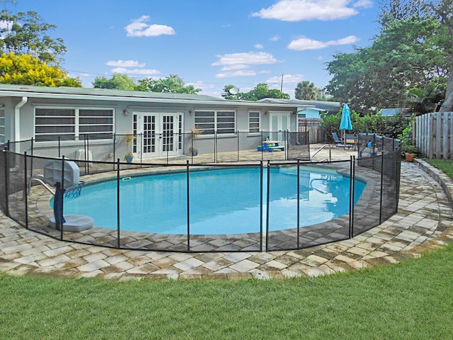 view of swimming pool featuring a patio and french doors