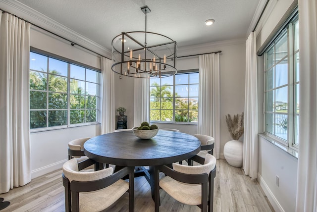 dining space featuring light hardwood / wood-style floors, crown molding, and a notable chandelier