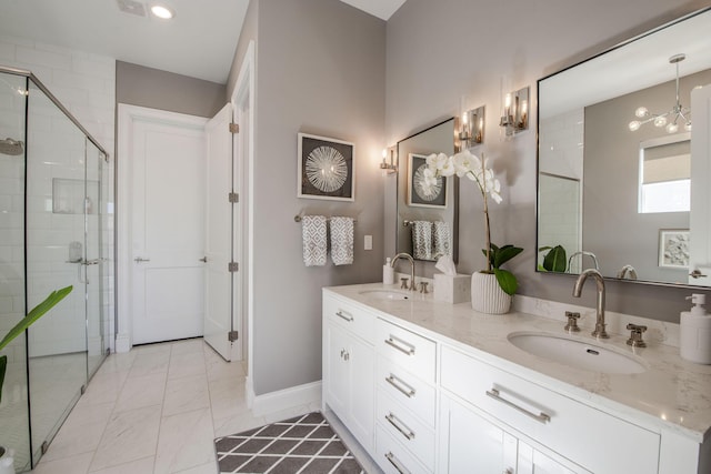 bathroom featuring vanity and a shower with door