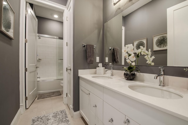 full bathroom featuring toilet, bath / shower combo with glass door, tile patterned floors, and vanity