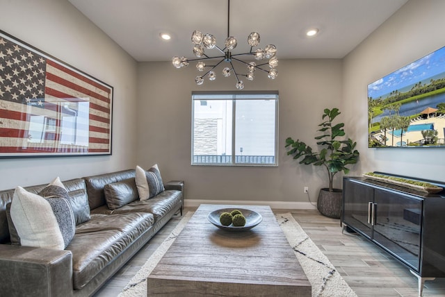 living room featuring light wood-type flooring and a notable chandelier