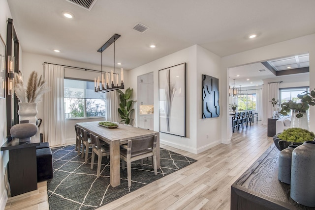 dining room featuring light hardwood / wood-style flooring and a chandelier