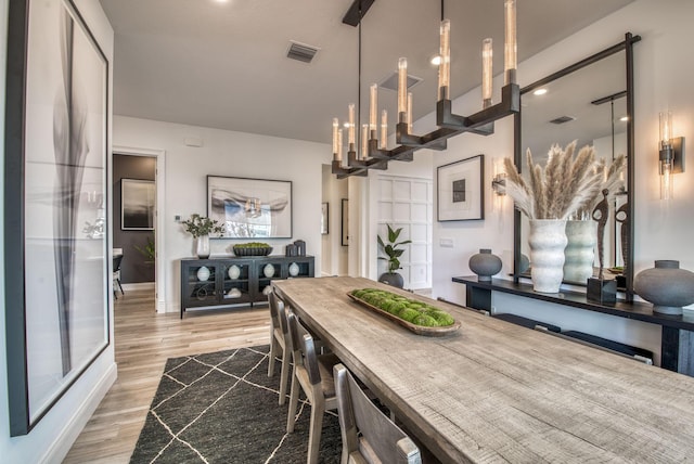 dining space with hardwood / wood-style floors