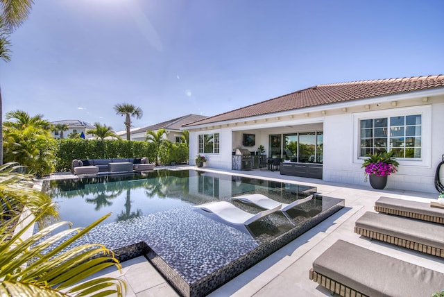 view of pool with an outdoor hangout area, area for grilling, and a patio