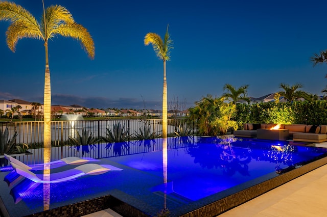 view of pool at dusk