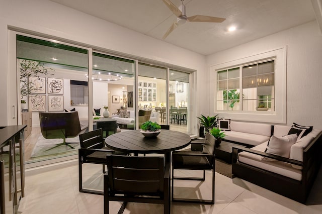 sunroom / solarium featuring ceiling fan