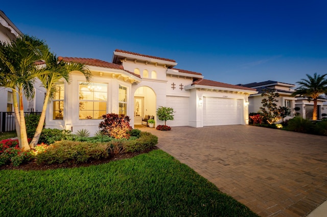 mediterranean / spanish-style house with a garage