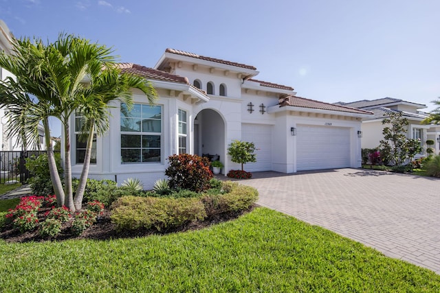 mediterranean / spanish house with a garage